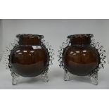 A pair of semi-opaque aubergine coloured and clear glass, globular vases, in the manner of