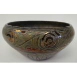 A Clemont Masier Art glass bowl of bulbous form with an inverted rim, decorated with scrolled and