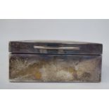 A silver cigarette box with straight sides, a hinged lid and cedar lined interior  London marks