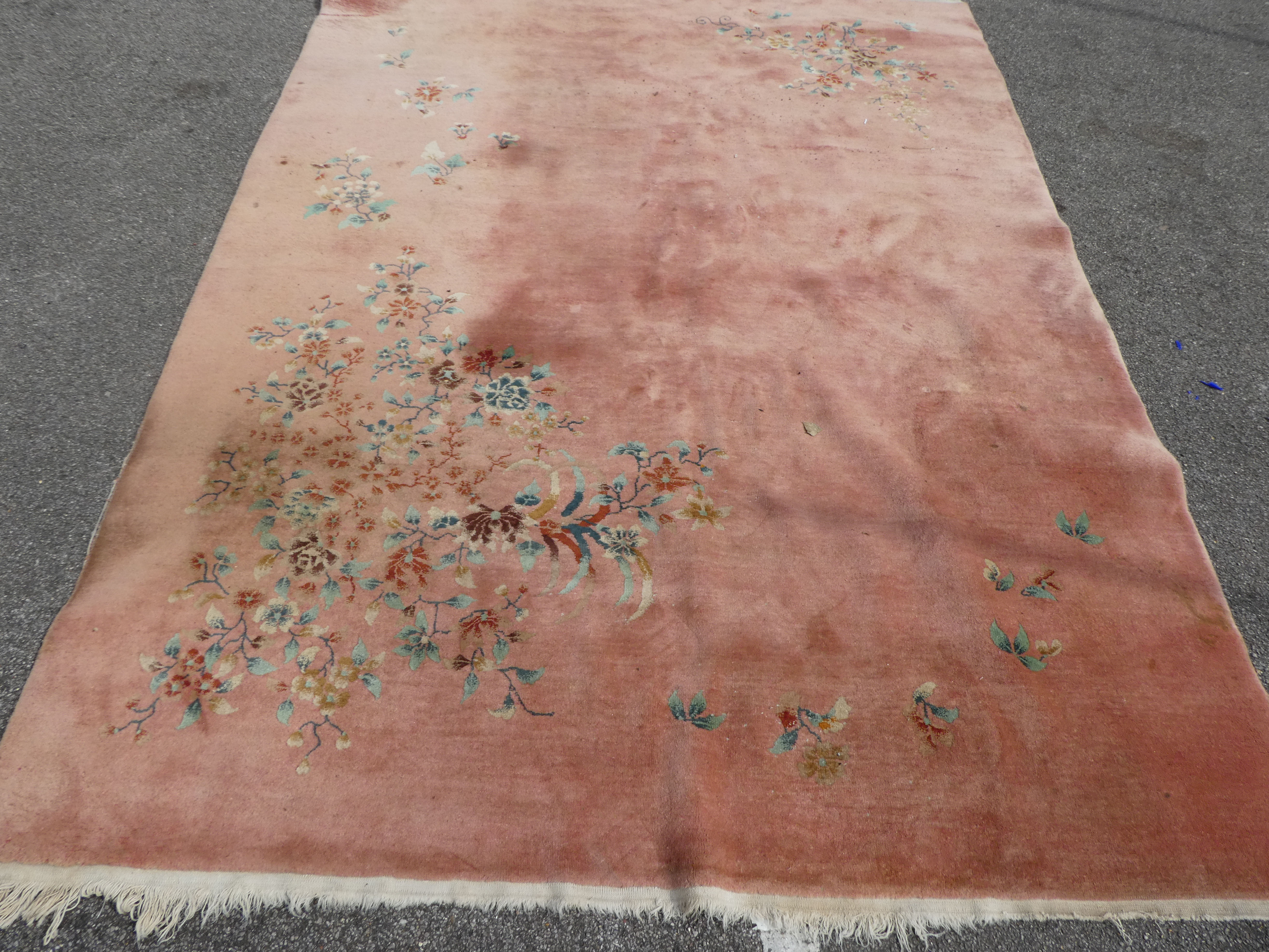 A Chinese washed woollen rug, decorated with flora, on a salmon pink coloured ground  100" x 148" - Image 4 of 7