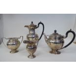 A four piece silver tea set of bulbous, pedestal form with egg and dart borders, engraved, ribbon