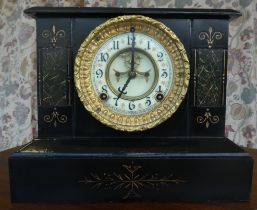 An early/mid 20thC black painted metal cased mantel clock; the movement faced by an Arabic dial,