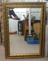 A modern mirror, the bevelled plate set in a textured effect and moulded gilt frame  32" x 44"