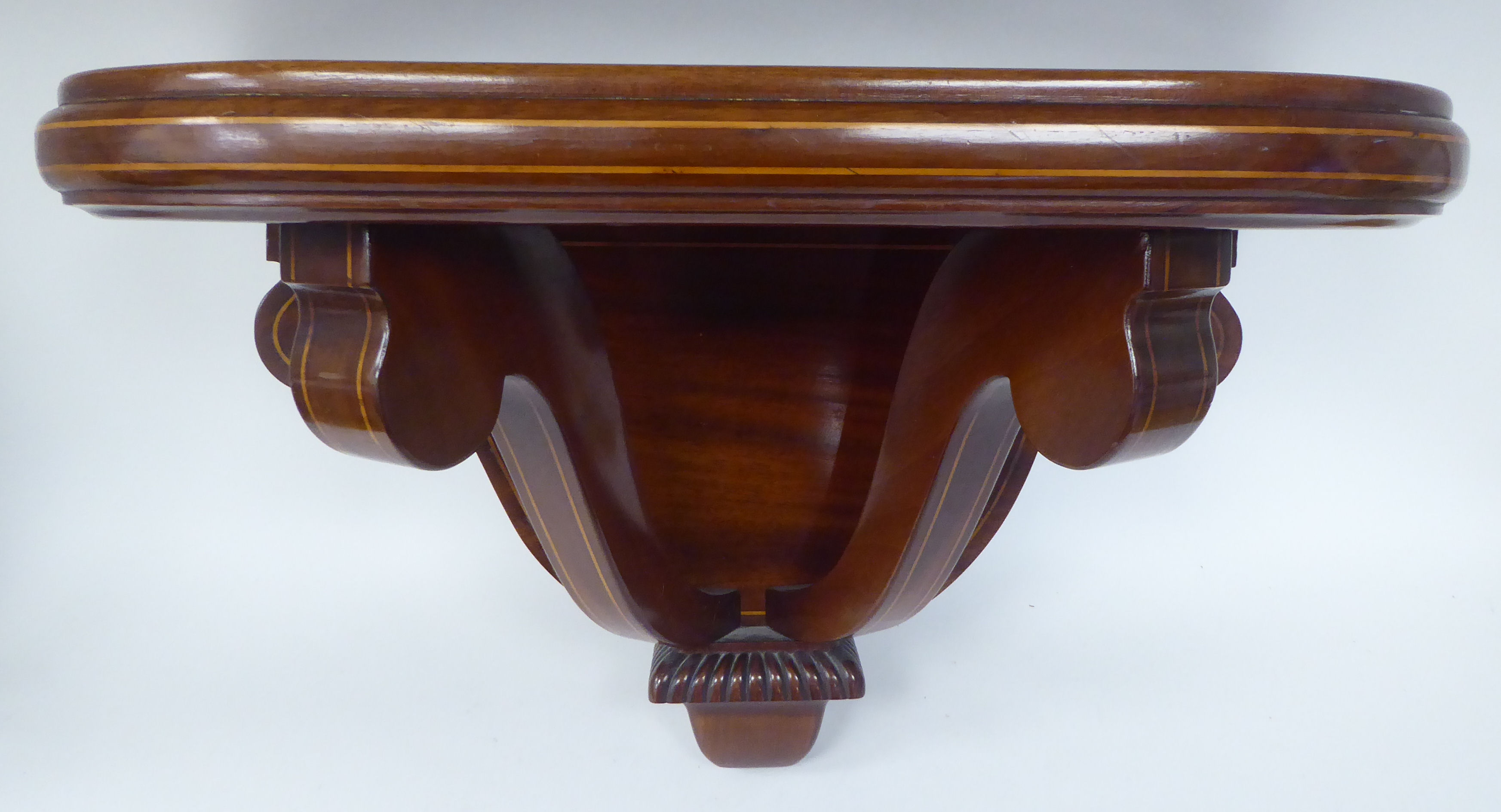 An Edwardian string inlaid mahogany wall bracket  13"h  20"w  9.5"deep