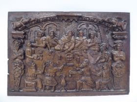 A 19thC 'The Last Supper' oak wall panel, carved in high relief with an interior scene, figures