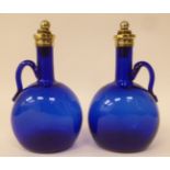 A pair of antique Bristol blue glass decanters of  bulbous form with narrow necks, strap handles,