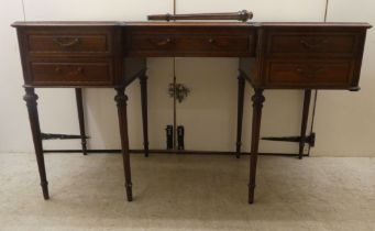 An early 20thC French inspired mahogany inverted breakfront, five drawer dressing table, raised on