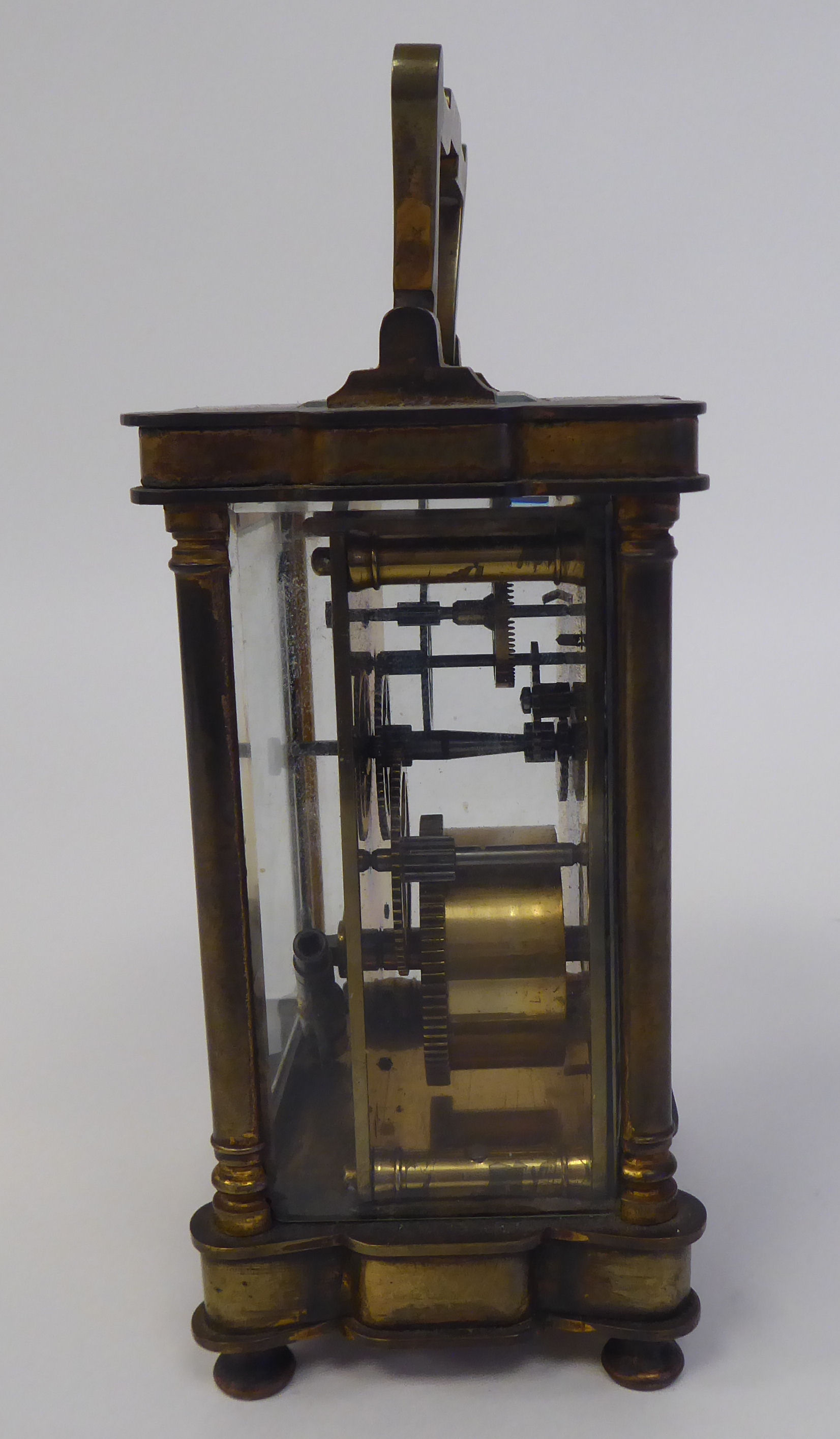 A 1920s lacquered brass cased carriage timepiece with bevelled glass panels and a folding top - Bild 6 aus 6