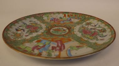 A 19thC Canton porcelain dish, decorated in panels and gilding with alternating conversational