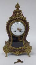 A 19thC French red boulle cased mantel clock of waisted form with gilt metal mounts; the bell strike