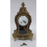 A 19thC French red boulle cased mantel clock of waisted form with gilt metal mounts; the bell strike