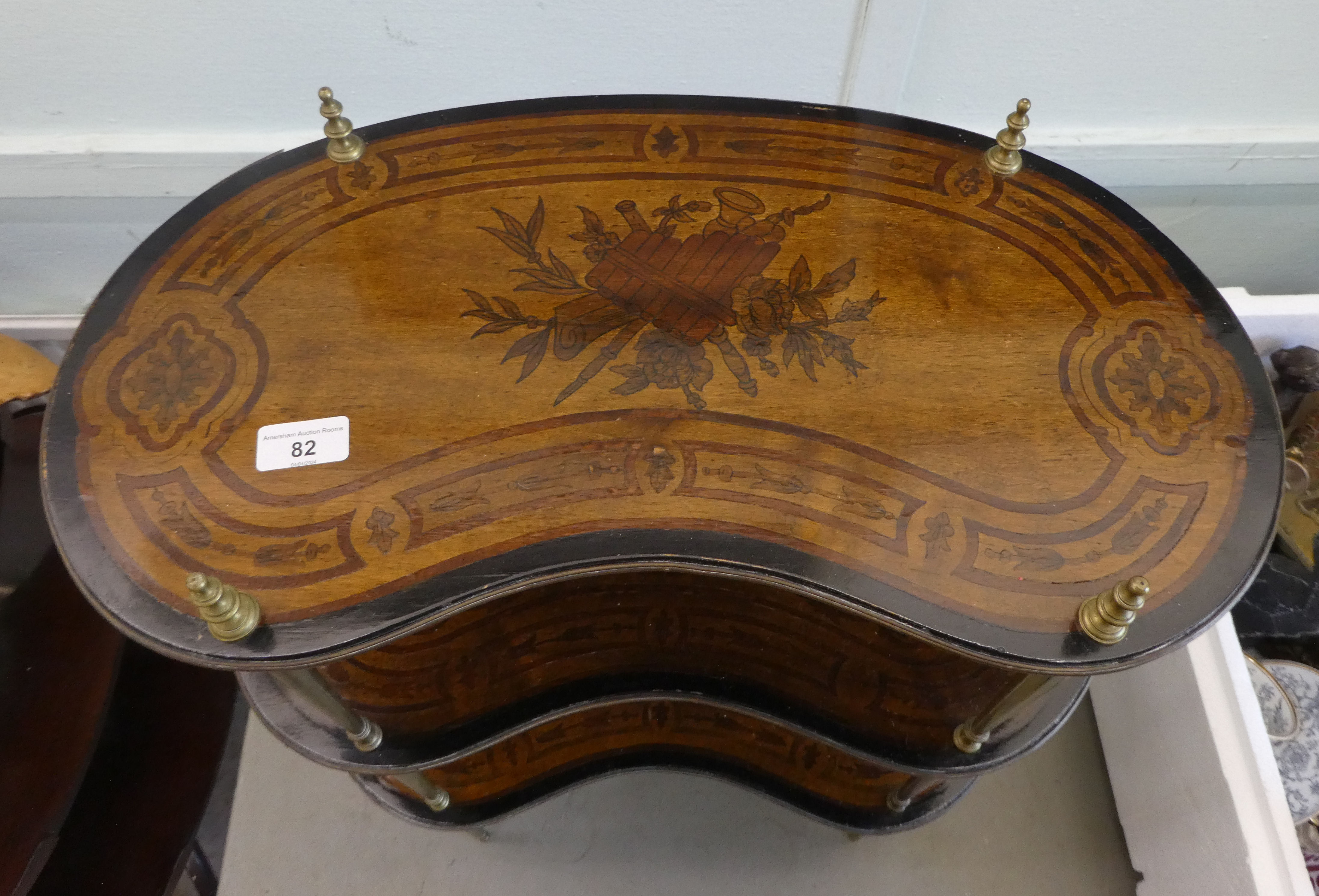 An early 20thC overpainted mahogany kidney shaped three tier whatnot, elevated on tapered, brass - Image 2 of 4