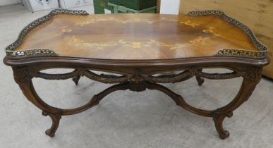 A 20thC reproduction of a 19thC Italian inspired marquetry rosewood finished coffee table with a