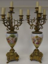 A pair of 20thC decoratively cast brass and painted ovoid shape ceramic table lamps, each comprising