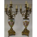 A pair of 20thC decoratively cast brass and painted ovoid shape ceramic table lamps, each comprising
