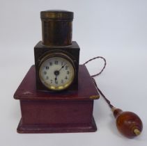 A vintage lacquered brass and maroon hide covered, battery operated pigeon racer's timepiece,