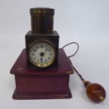 A vintage lacquered brass and maroon hide covered, battery operated pigeon racer's timepiece,