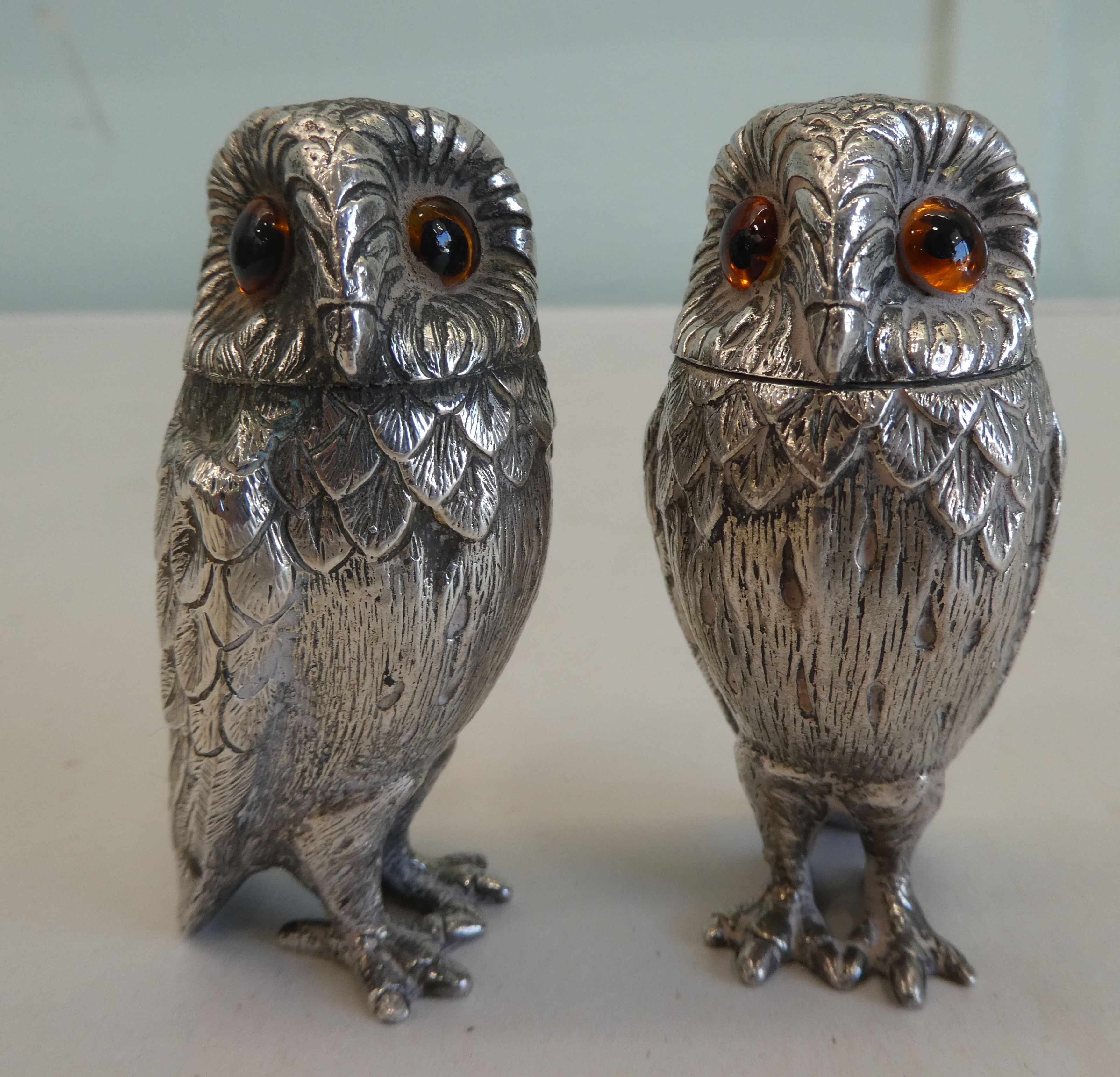 A pair of silver coloured metal novelty salt and pepper shakers, fashioned as owls