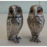 A pair of silver coloured metal novelty salt and pepper shakers, fashioned as owls