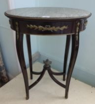 A 20thC reproduction of a late 19thC Continental hall table, the oval marble top over a frieze