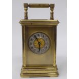 A mid 20thC lacquered brass cased carriage clock with bead bordered ornament, bevelled glass