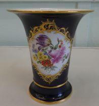 A modern Meissen porcelain tapered vase, decorated with flora and gilding, on a midnight blue ground