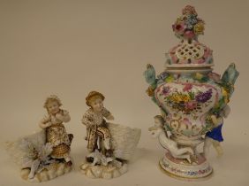 A pair of 20thC Continental porcelain figures, a boy and girl with a basket of flowers  5"h; and a