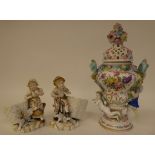 A pair of 20thC Continental porcelain figures, a boy and girl with a basket of flowers  5"h; and a