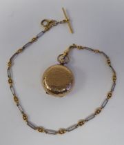 A 9ct gold spot-hammered pendant sovereign case, on a fancy link chain with a T-bar and ring bolt