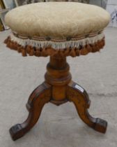 An Edwardian stool, the later fabric upholstered circular seat raised on a fruitwood tripod base