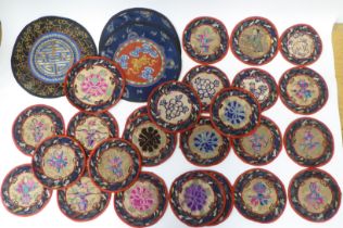Approx. thirty 20thC Chinese fabric roundel table mats, embroidered in coloured silk and yellow