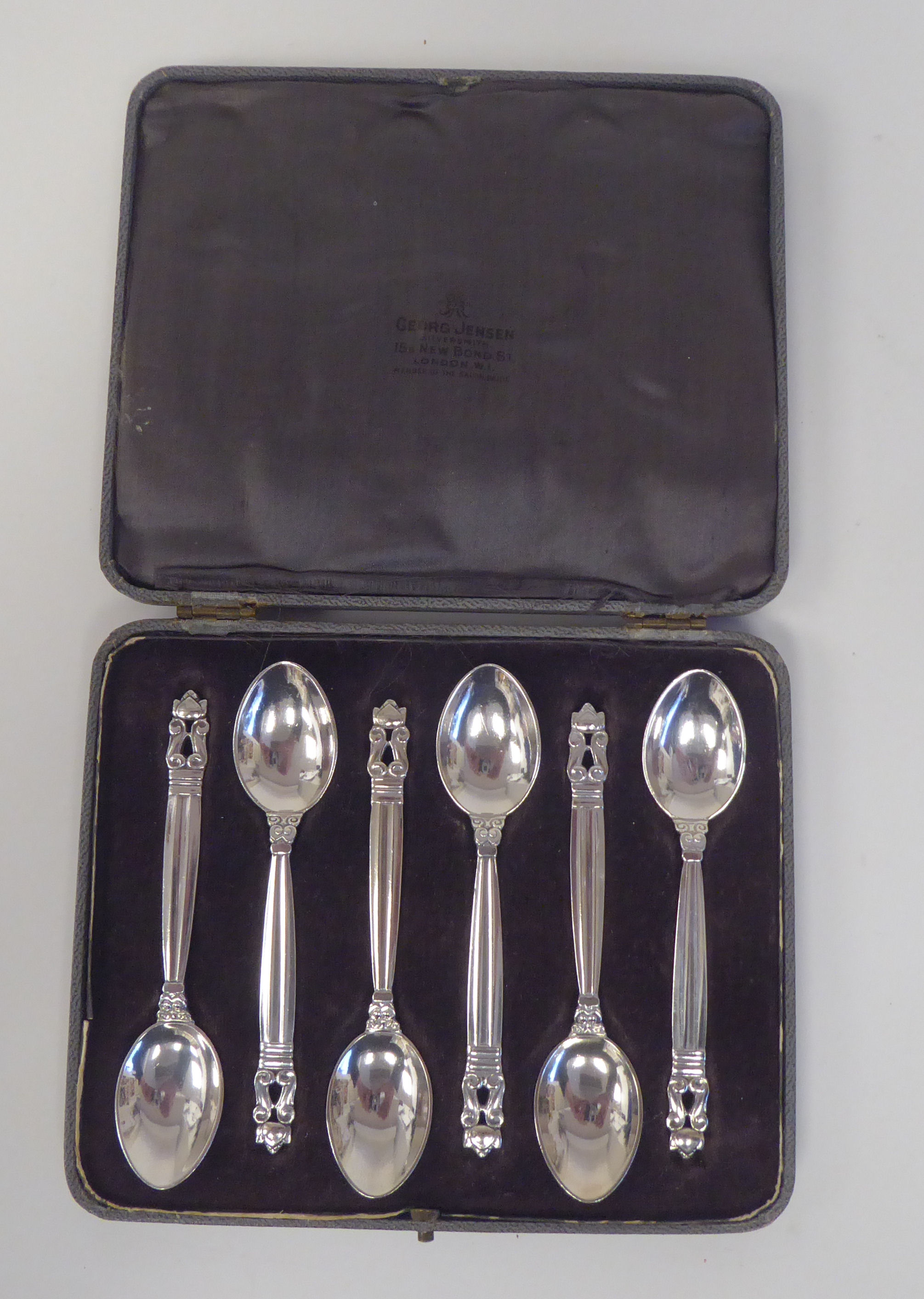 A set of six Georg Jensen silver teaspoons with scrolled terminals  stamped 925  cased