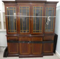 An Edwardian string and crossbanded mahogany breakfront bookcase, the moulded cornice over four