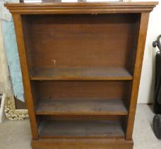 An early 20thC mahogany open front bookcase with two height adjustable shelves, on a plinth  42"h