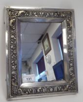 A Russian silver coloured metal icon frame, the mitred wide border decorated