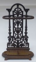 A late Victorian cast iron stickstand, the pierced upstand decorated with vase and floral