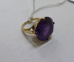 A 9ct gold cocktail ring, set with a purple stone