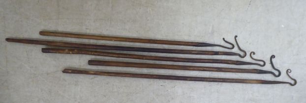 Five vintage wooden handled shepherds' crooks with steel heads