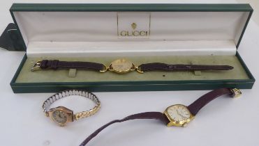 Three ladies wristwatches: to include a Gucci example, faced by a Roman dial, on a brown hide strap