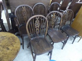 A set of six 20thC stained beech framed Windsor chairs  comprising four standard/two open arm