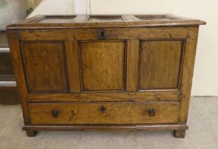 A late 18thC oak mule chest with a tri-panelled, hinged lid and front panel, over a drawer, raised