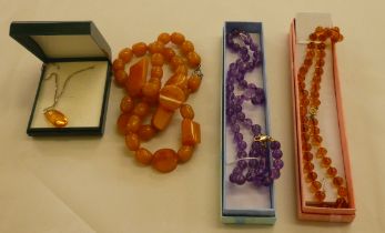 Costume jewellery, viz. three coloured bead necklaces; and a pendant, featuring an amber coloured