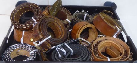 An assortment of leather belts and buckles: to include one from Calgary and another from Idaho