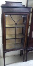 An Edwardian mahogany single glazed door display cabinet, raised on square legs  58"h  23"w