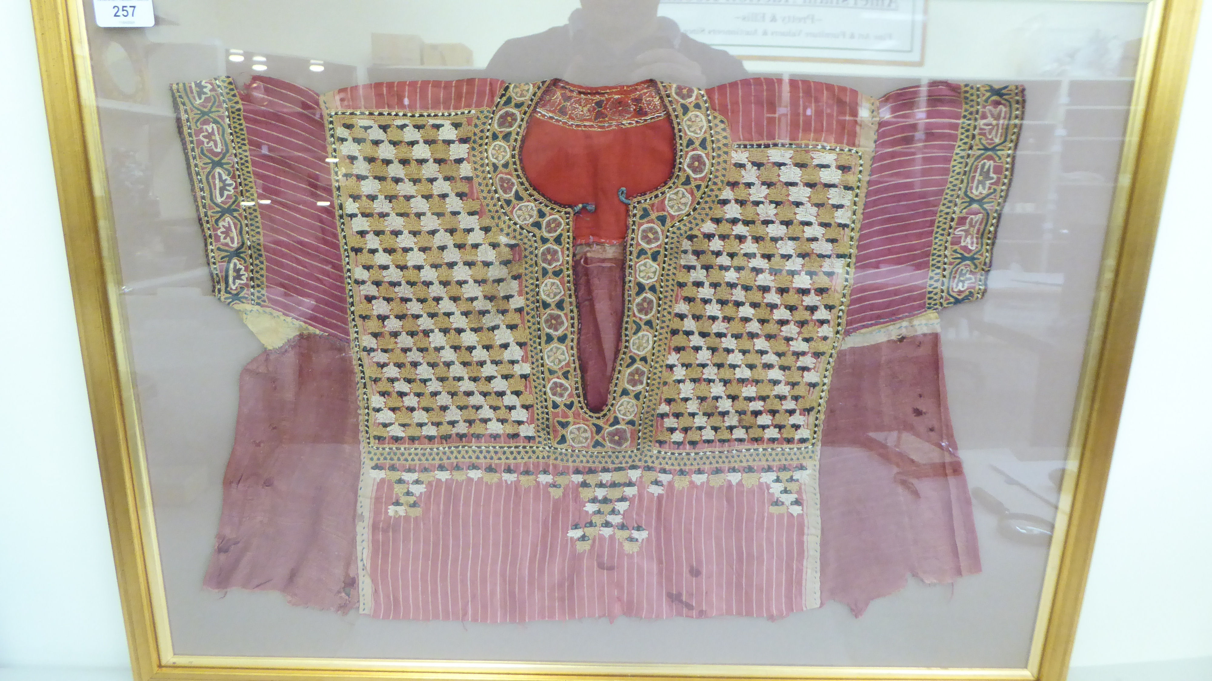 An Asian antique tunic, richly embroidered in colours  16" x 22" overall  framed - Image 2 of 2