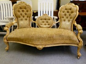 A late 19th/early 20thC carved cream painted showwood framed, waisted double spoon back settee,