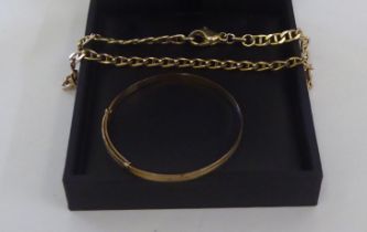A gold coloured metal flat link bracelet, on a dog-clip clasp; and a child's 9ct gold expandable