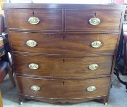 A late Victorian mahogany bow front five drawer dressing chest, raised on block feet and casters