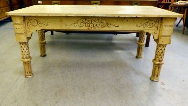 A 20thC coffee table, painted in shabby chic pastel colours, raised on decoratively carved and