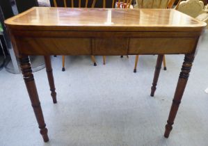 A Regency mahogany card table with a foldover top, raised on turned, tapered legs  28"h  35"w